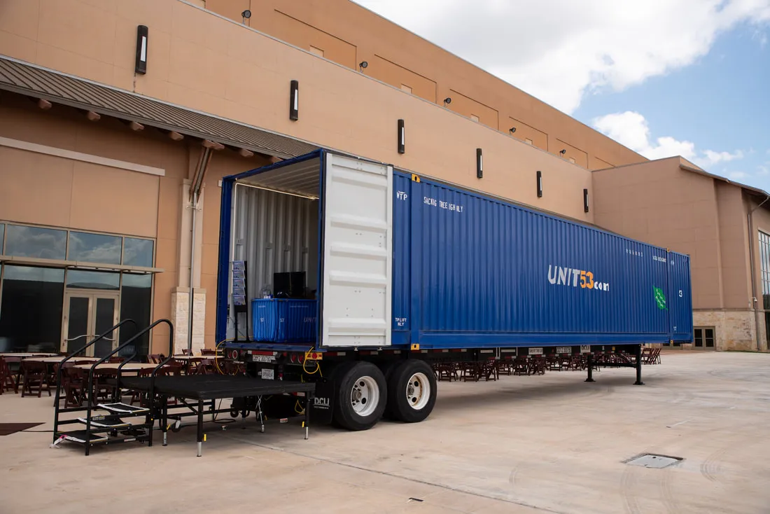 A blue shipping container on a trailer chassis outside the 2026 NPSA trade show